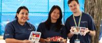 Three nursing students displaying healthy snacks for the community.